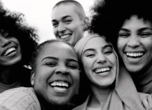 Happy group of multiracial women having fun outdoors - Real people from different ethnicity celebrating outdoors - Lifestyle and youth culture concept - Black and white editing